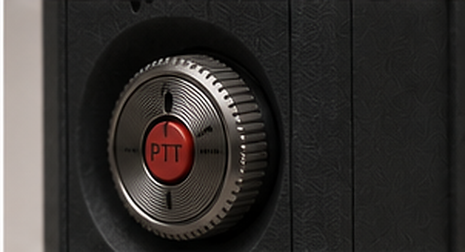 Macro close-up of the Pocket Messenger's knurled metal wheel with its red PTT center button