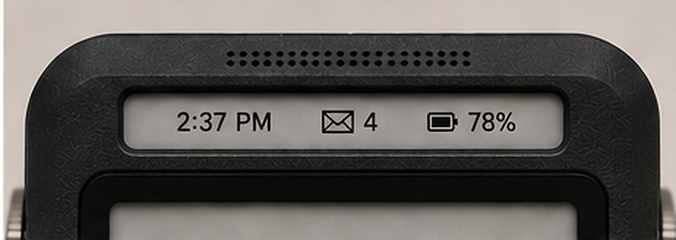 Close-up of the top-edge e-ink glance display showing time, unread message count, and battery percentage above the speaker grille