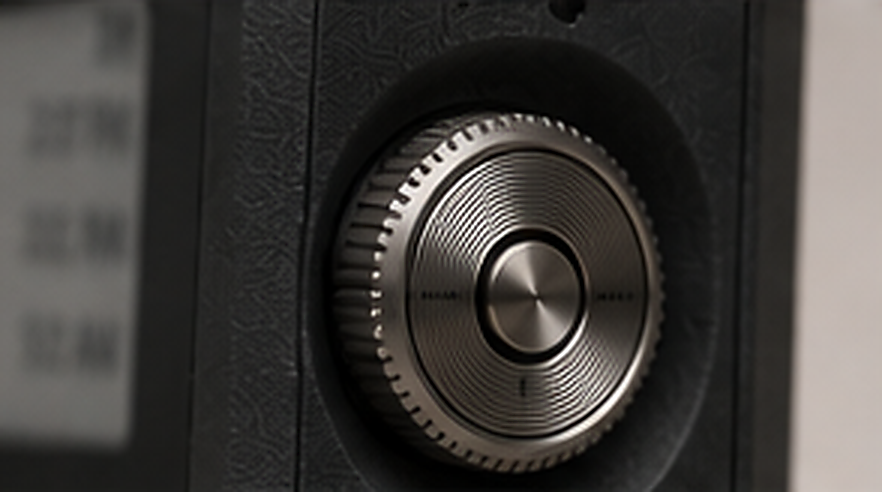 Macro detail of the knurled metal scroll wheel recessed into the matte textured housing